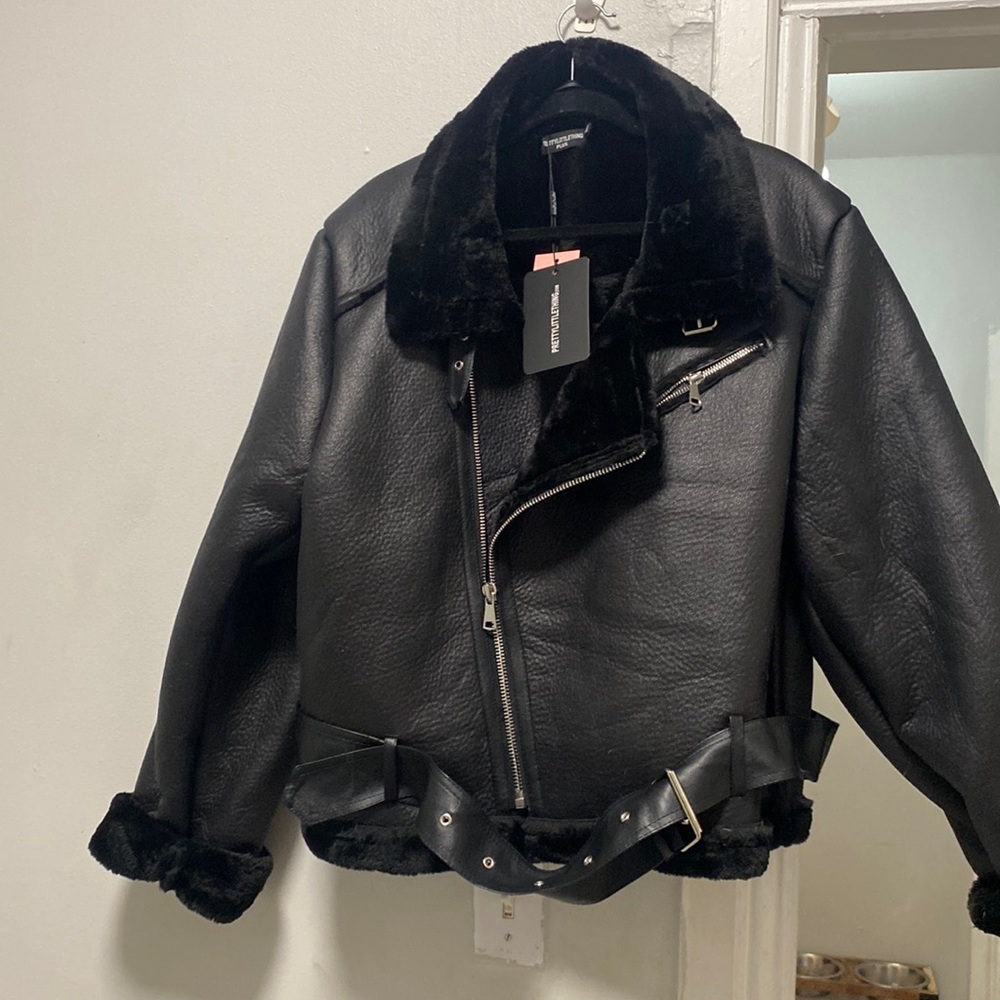 This is a never worn, very pretty faux leather jacket from PrettyLittleThing.